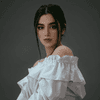 A woman with dark hair in a white off-shoulder blouse
