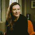 Dr. Amelia Hart smiling in a black sweater